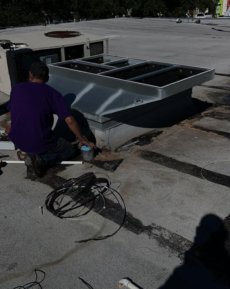 Professional HVAC contractor servicing central air unit at suburban home