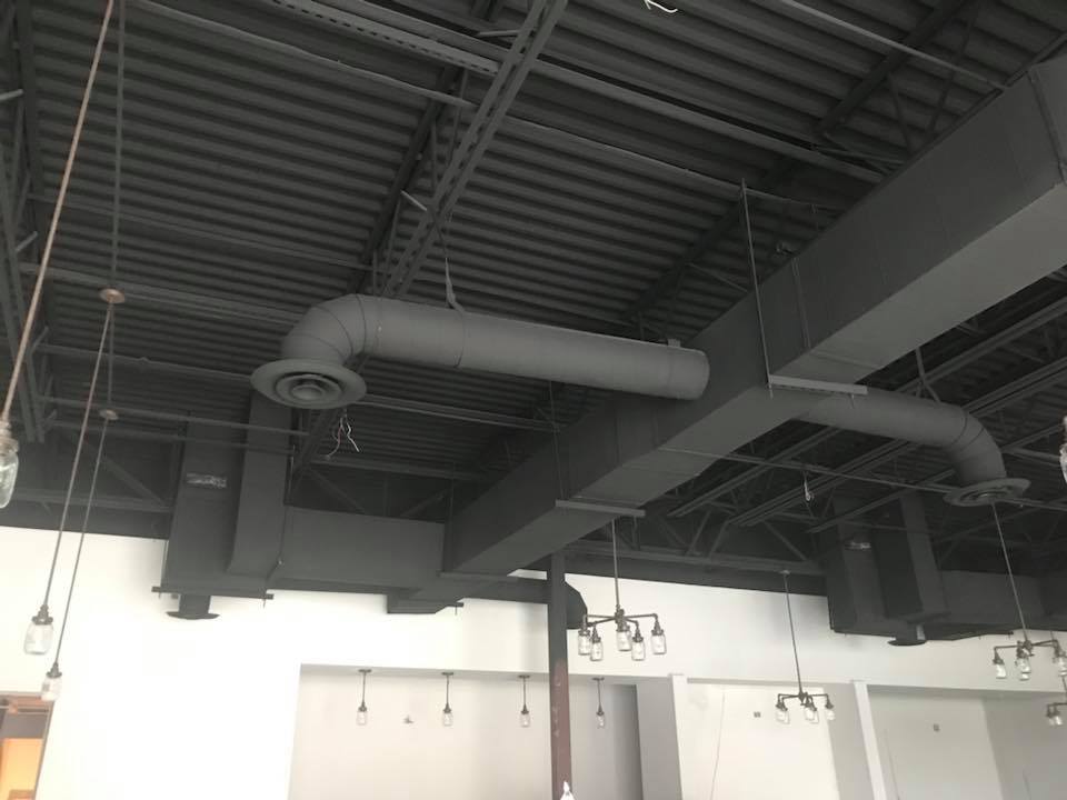 Global Air Service technician servicing HVAC unit at Houston home, trusted provider